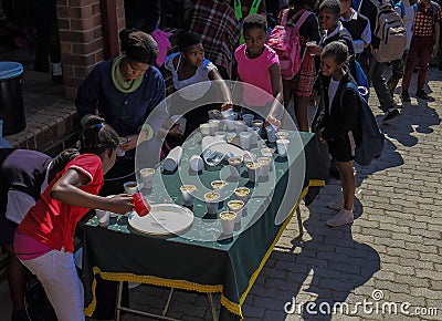 Poor school children receiving food at a soup kitchen Editorial Stock Photo