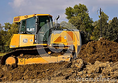 John Deere bulldozer pushes earth Editorial Stock Photo