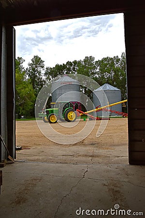 John Deere 7320 hooked up a grain elevator Editorial Stock Photo