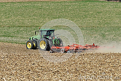 John Deere 8400R tractor pulling a Kuhn Excelerator 8000 tiller Editorial Stock Photo