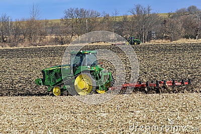 John Deere 8420T track drive tractor pulling a White 445 disk chisel plow Editorial Stock Photo