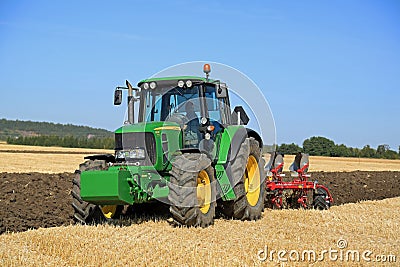 John Deere 6630 Tractor and Agrolux Plow on Field Editorial Stock Photo