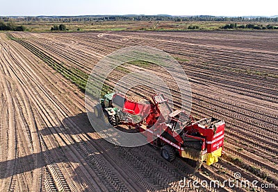 John Deere Tractor with GRIMME SE 150-60 Potato Harvester and separator. Editorial Stock Photo