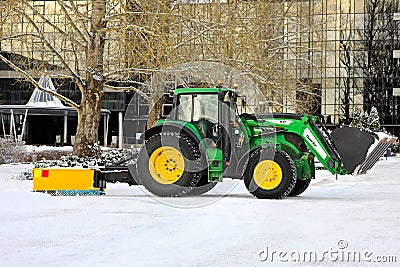 John Deere Tractor Removing Snow with Front End Loader and Rear Blade Editorial Stock Photo