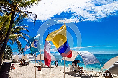 JOHNNY CAY, COLOMBIA - OCTOBER 21, 2017: Unidentified people sitting a chair in the beach and enjoying the beautiful Editorial Stock Photo