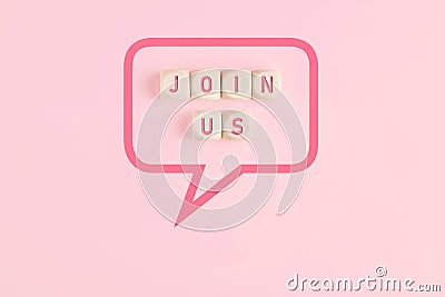 Join us message on wooden cubes framed by a speech bubble on pink background Stock Photo