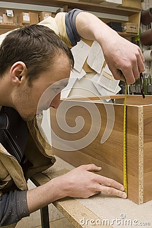 Joiner making furniture in his manufactory Stock Photo