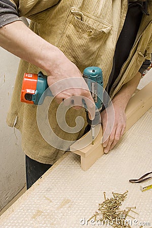 Joiner making furniture in his manufactory Stock Photo