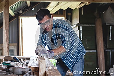 Joiner planes wood hand planing machine in the home workshop.Private entrepreneur working at his workplace Stock Photo