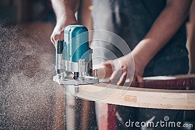 Joinery, woodworking and furniture making, professional carpenter cutting wood in carpentry shop, industrial concept Stock Photo