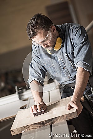 Joinery man polishing up wood Stock Photo