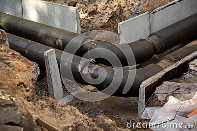 Jointed steel pipes and bends insulated with polymer mineral foam insulation. Construction process of heating tracks Stock Photo