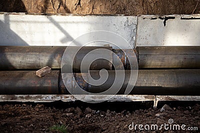 Jointed steel pipes insulated with polymer mineral foam insulation. Construction process of the heating tracks. Stock Photo