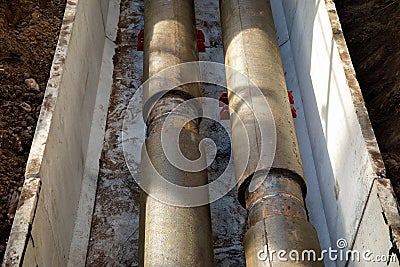 Jointed steel pipes insulated with polymer-mineral insulation in concrete slabs. Process of construction of heating Stock Photo