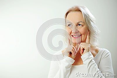 Human emotions and feelings adult cute woman looks into the frame and laughs shy and shakes her head closes her eyes Stock Photo