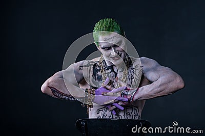 Joker from a Suicide Squad comics on a black background. Professional make-up Editorial Stock Photo