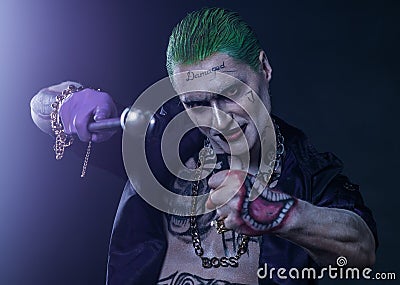 Joker from a Suicide Squad comics on a black background. Professional make-up Editorial Stock Photo