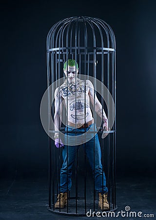 Joker from a Suicide Squad comics on a black background. Professional make-up Stock Photo