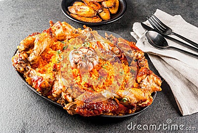 Jollof rice with chicken and plantains Stock Photo