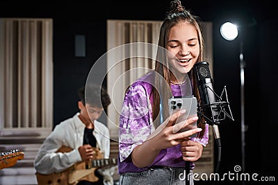 jolly adorable teenage girl singing and Stock Photo