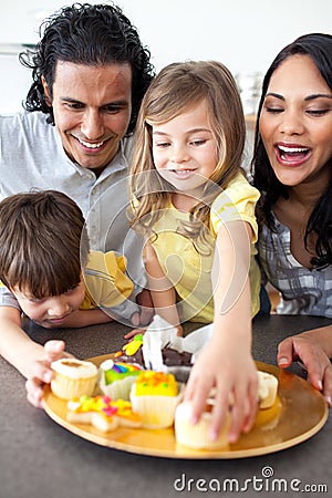 Jolly family eating cookies Stock Photo