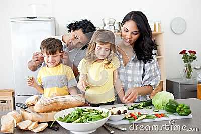 Jolly family preparing lunch together Stock Photo