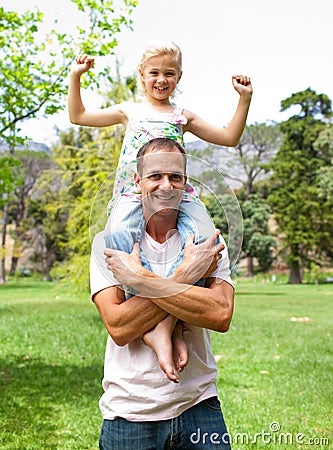 Jolly father giving his daughter piggy-back ride Stock Photo