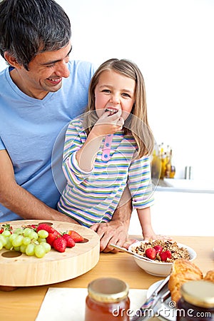 Jolly father and his daughter having breakfast Stock Photo