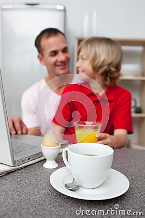 Jolly father and his son having breakfast Stock Photo