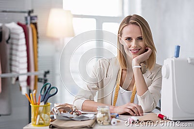 Jolly female couturier planning new collection Stock Photo