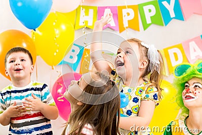 Jolly kids group celebrating birthday party Stock Photo