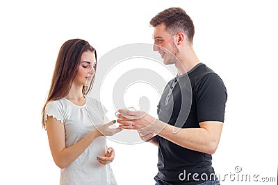 Jolly nice guy stands near the young girl and gives her a cup of tea Stock Photo