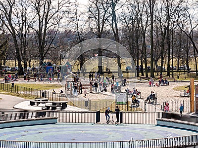 Jordan park playground in Krakow, public area during covid 19 pandemic group of people adults and children in face masks new Editorial Stock Photo