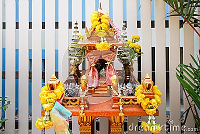 Joss house in thailand with flowers in vases and some wreathes Stock Photo