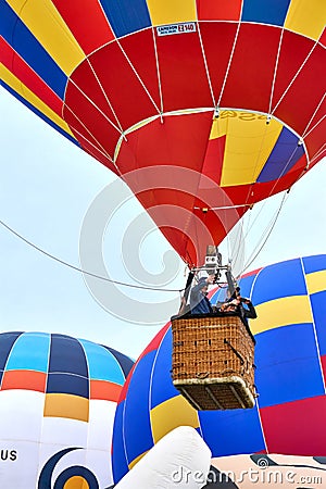 Large hot air balloon rising above multi coloured balloons Editorial Stock Photo