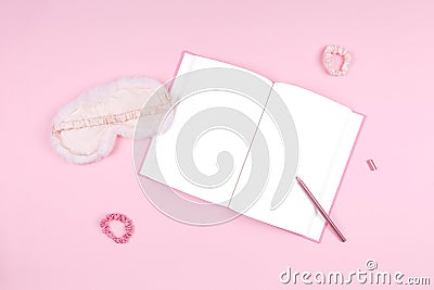 Journal with cute white fluffy sleep mask and pink accessories Stock Photo