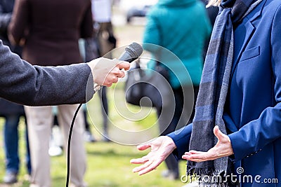 Journalist making media interview with elegant female politician, business woman or spokeswoman Stock Photo