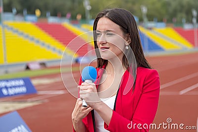 The journalist is reporting from the stadium Stock Photo