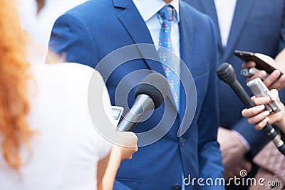 Journalists making media interview with unrecognizable business person or politician Stock Photo