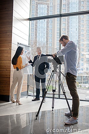 Journalists making a new program in the studio Stock Photo