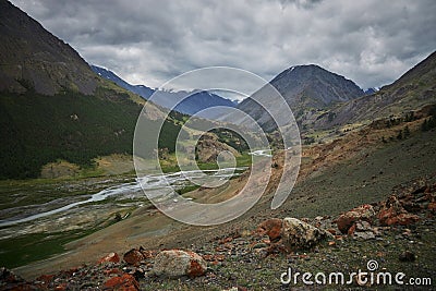 Journey through Altai Mountains, amazing nature of mountain peaks, rivers and streams flow down from slope of mountains. Altai Stock Photo