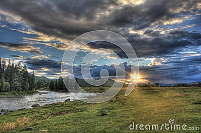 Journey through the wild nature of the Altai. Sunset in the valley of the mountain river Bashkaus. Stock Photo