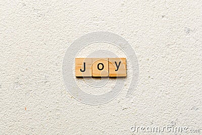 Joy word written on wood block. Joy text on cement table for your desing, concept Stock Photo