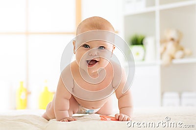 Joyful baby crawling on the floor in nursery room Stock Photo