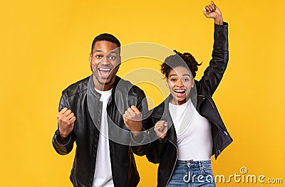 Joyful Black Spouses Gesturing Yes Posing Over Yellow Background Stock Photo