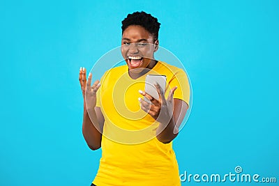 Joyful Black Woman Using Smartphone Posing Making Selfie, Blue Background Stock Photo
