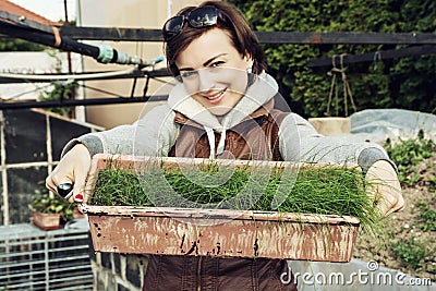 Joyful caucasian woman with pot of chive in the garden Stock Photo