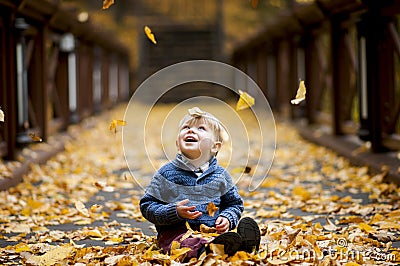 Joyful child admired by the fall of foliage Stock Photo