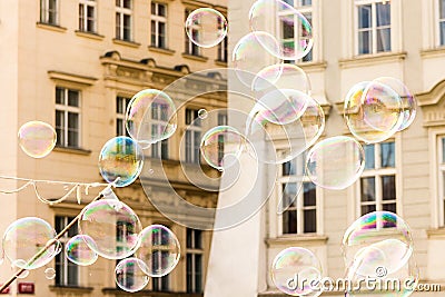 Joyful colorful background lots of transparent soap bubbles background of a facade of a European house lots of airy light bullets Stock Photo