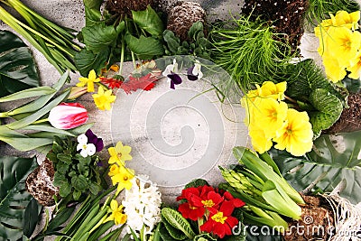 Joyful colorful spring background for a Happy easter with seasonal greeting text with rustic letter with flowers and tulips Stock Photo